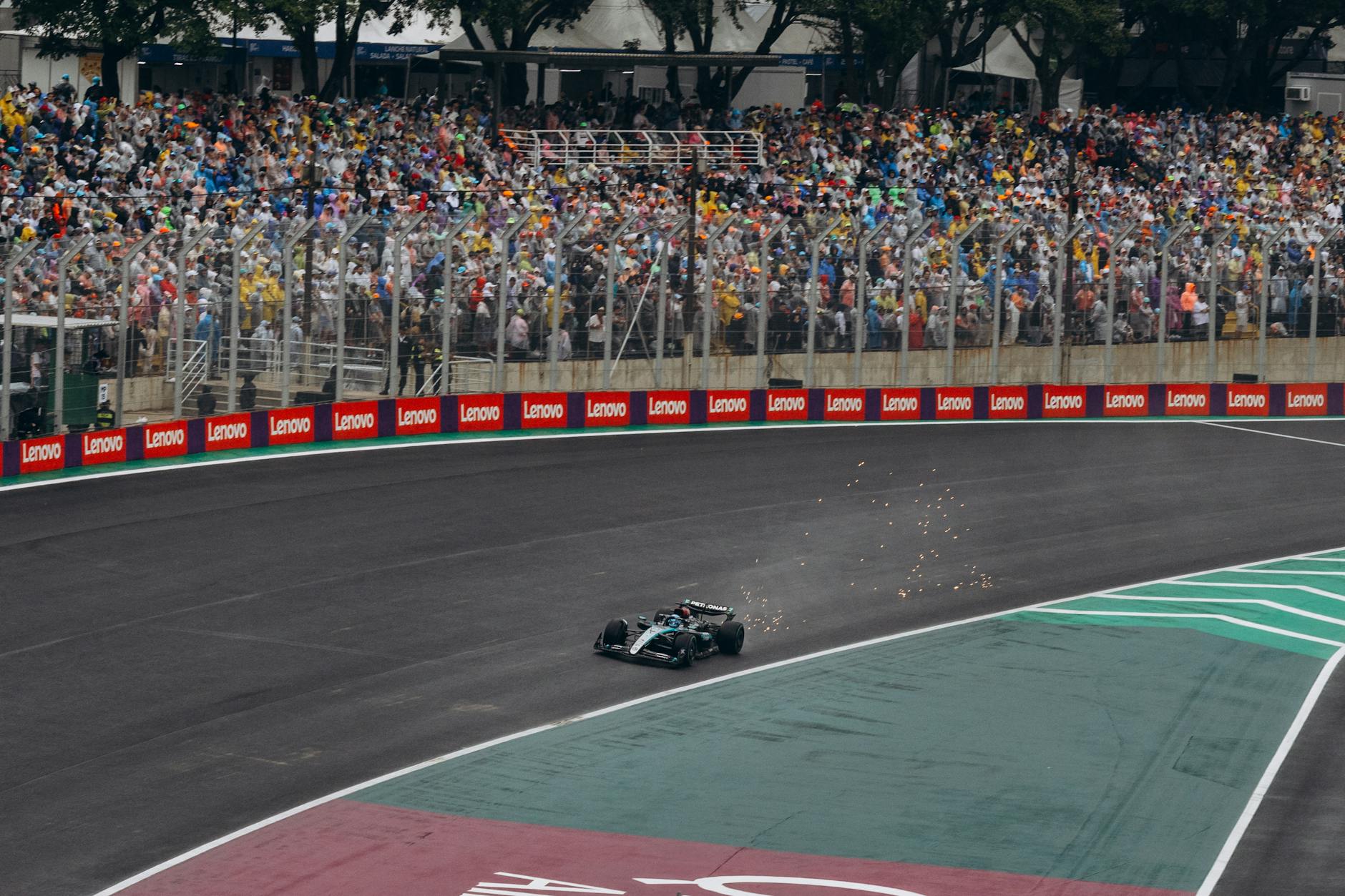 High-adrenaline moment captured during a Formula 1 race with a packed audience.