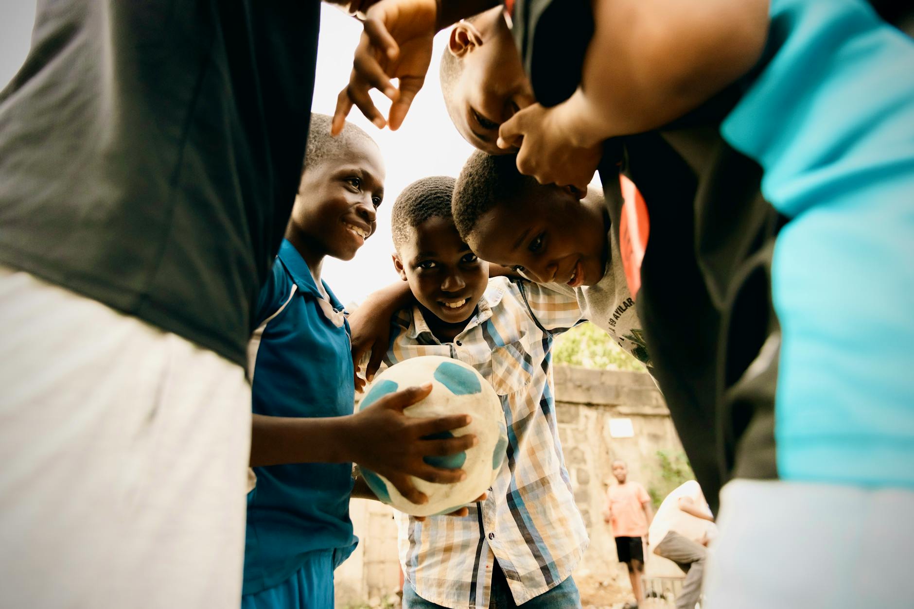 Group of boys enjoying a soccer game outdoors in Lagos, Nigeria.