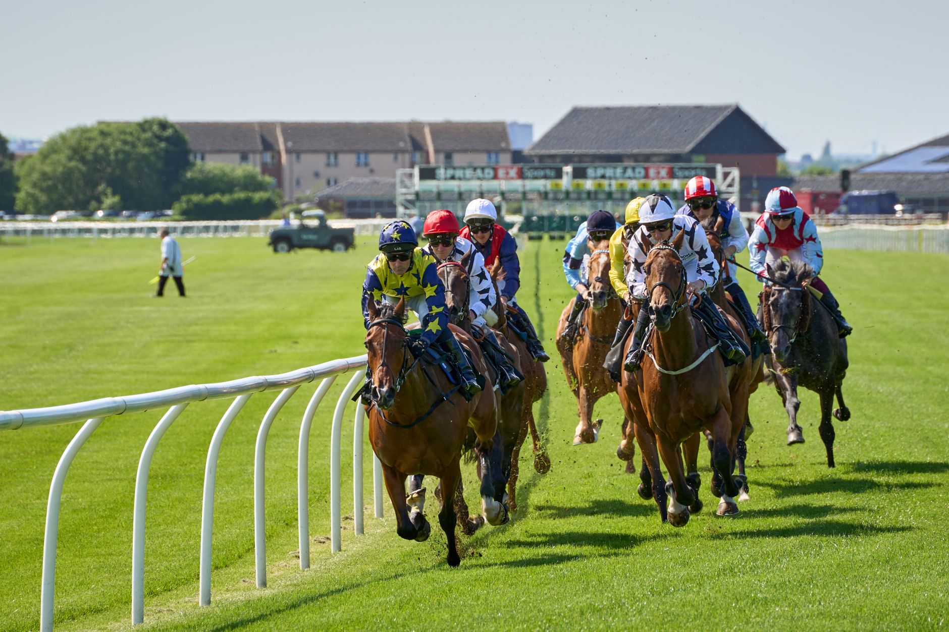 Dynamic view of a thrilling horse race with jockeys in action at Musselburgh Racecourse.