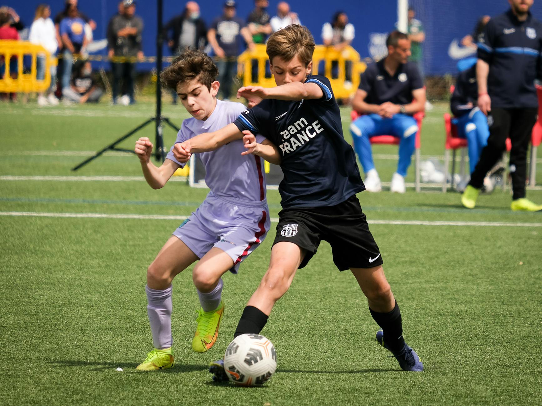 Young athletes compete in a lively soccer match in Barcellona, Italy, showcasing teamwork and sportsmanship.