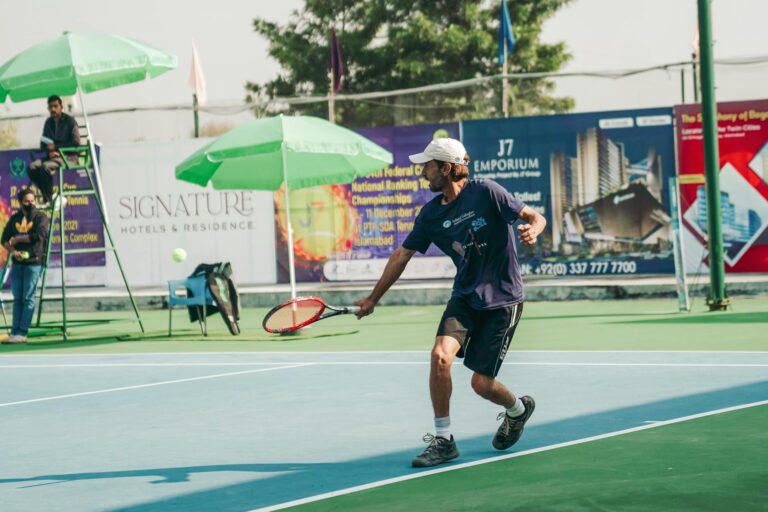 Tennis player in motion during a match on a sunny day in Islamabad. Perfect for sports and lifestyle themes.