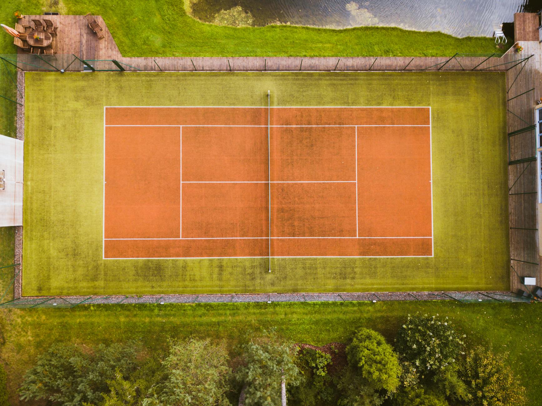 Drone captures aerial view of an empty tennis court in Aespa, Estonia.