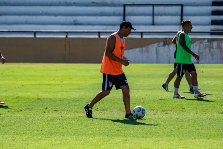 Athletes practice soccer on a sunny day, showcasing teamwork and skills.
