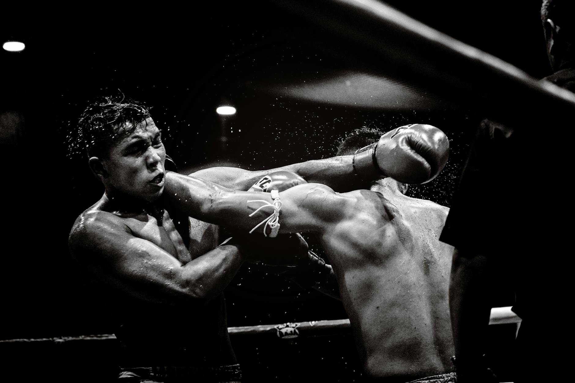 Dynamic black and white photo capturing a powerful moment in a boxing match.