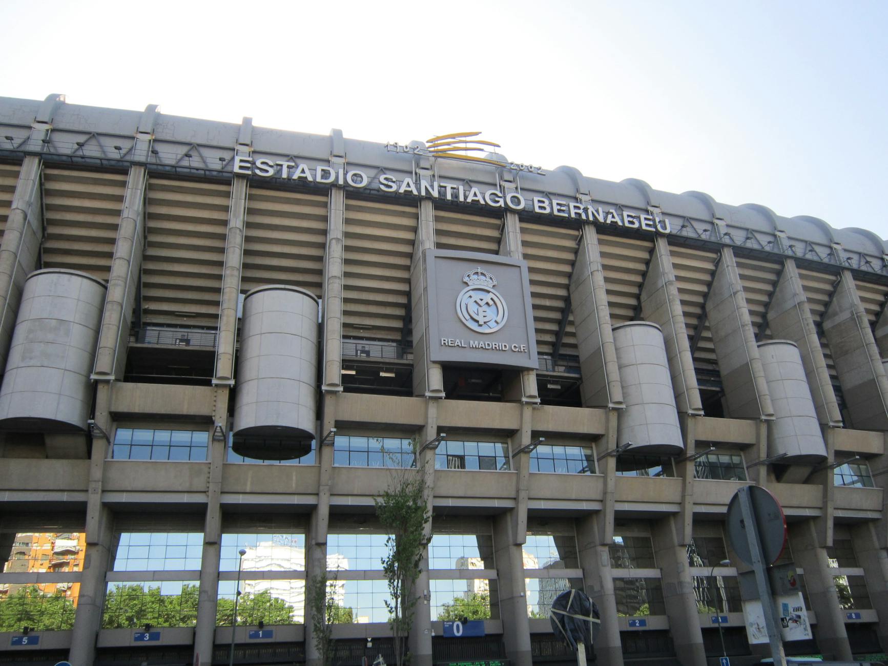 Impressive view of the iconic Santiago Bernabéu Stadium in Madrid, Spain, captured during a bright summer day.
