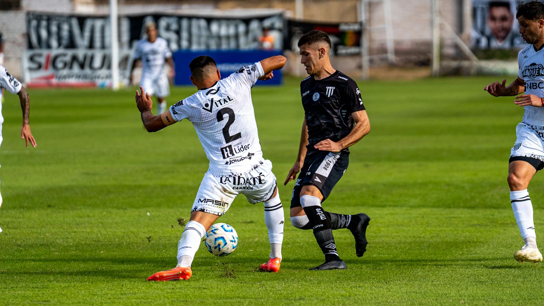 Action-packed soccer match with players in motion on a green field.