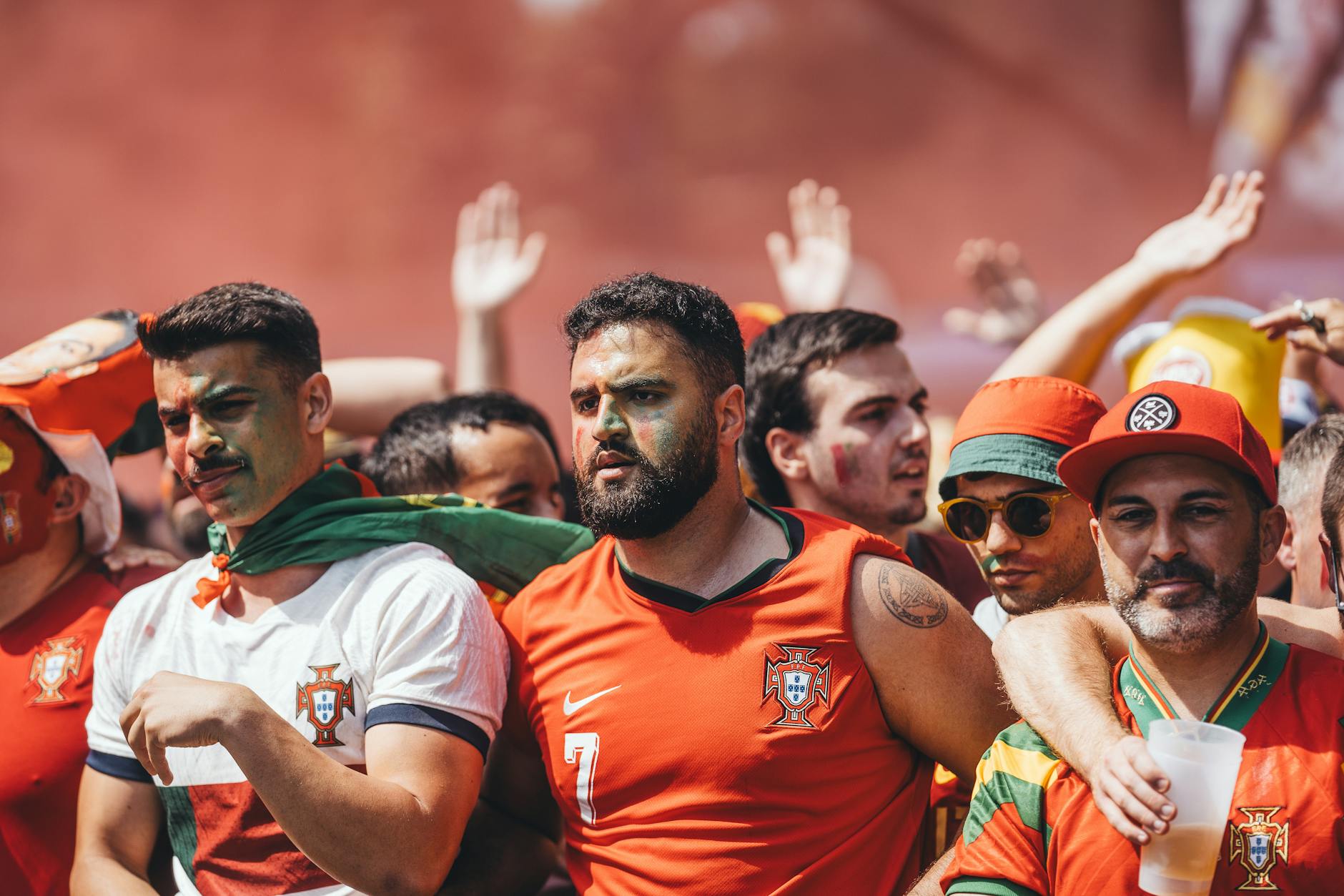 Group of passionate soccer fans cheering during a match, showcasing team spirit and celebration.