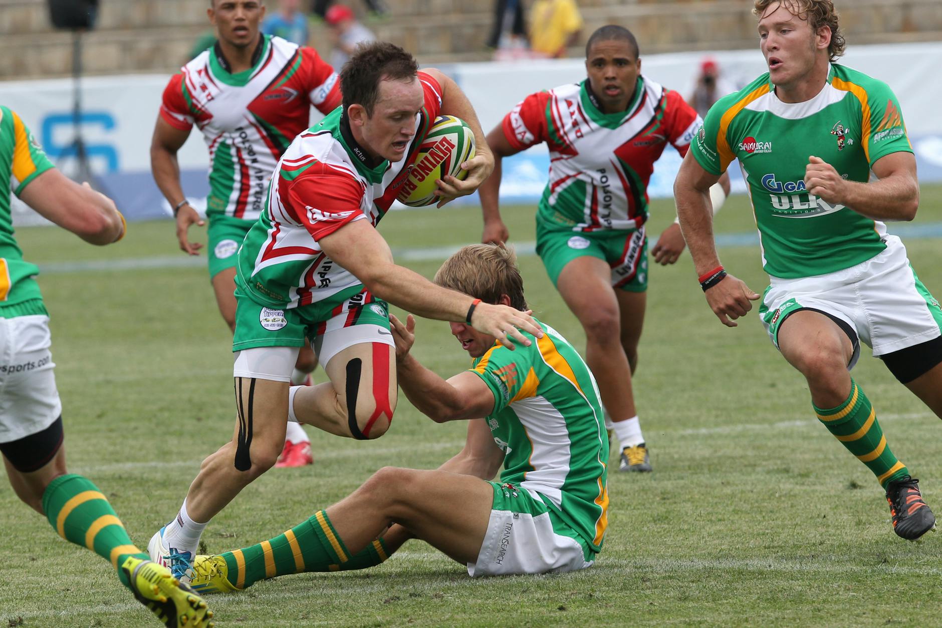 Rugby players in action during a competitive outdoor match.