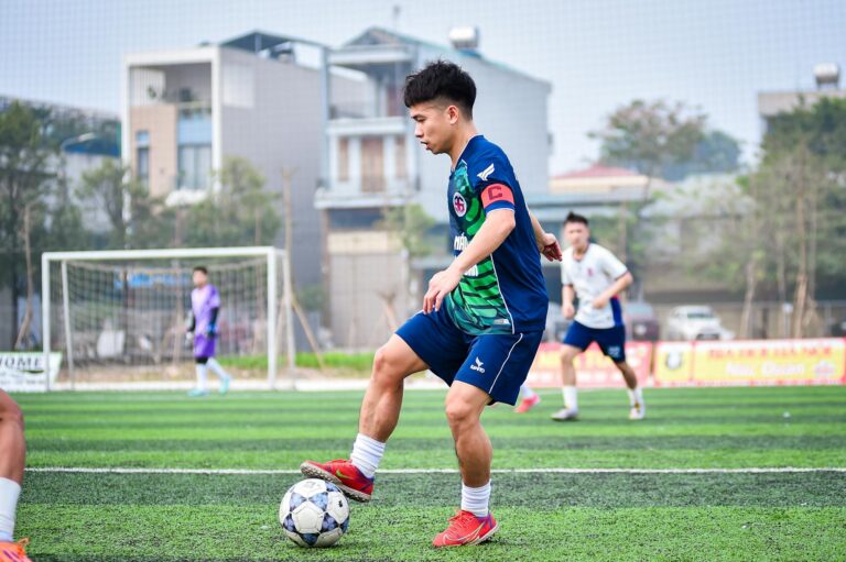 A young soccer player dribbles during a game on an artificial turf field in Hanoi, Vietnam.