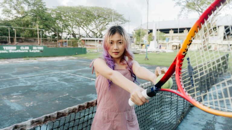 Young woman with tennis racket on an outdoor court in Southern Leyte.