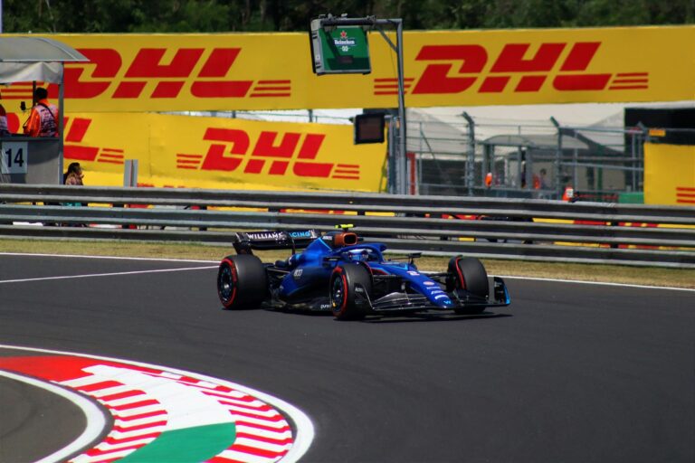 High-speed Formula 1 car on the track during a sunny day at Hungaroring, Hungary.