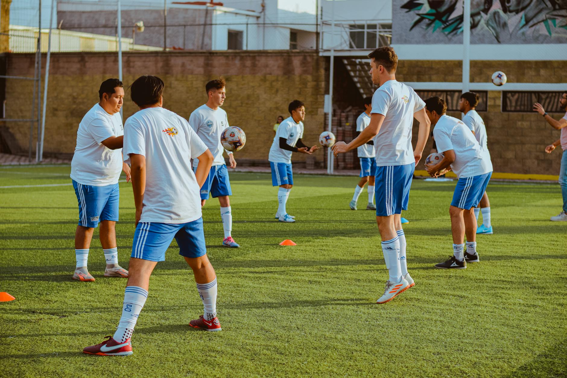 Dynamic image of a youth soccer team engaging in training drills on a sunny day.