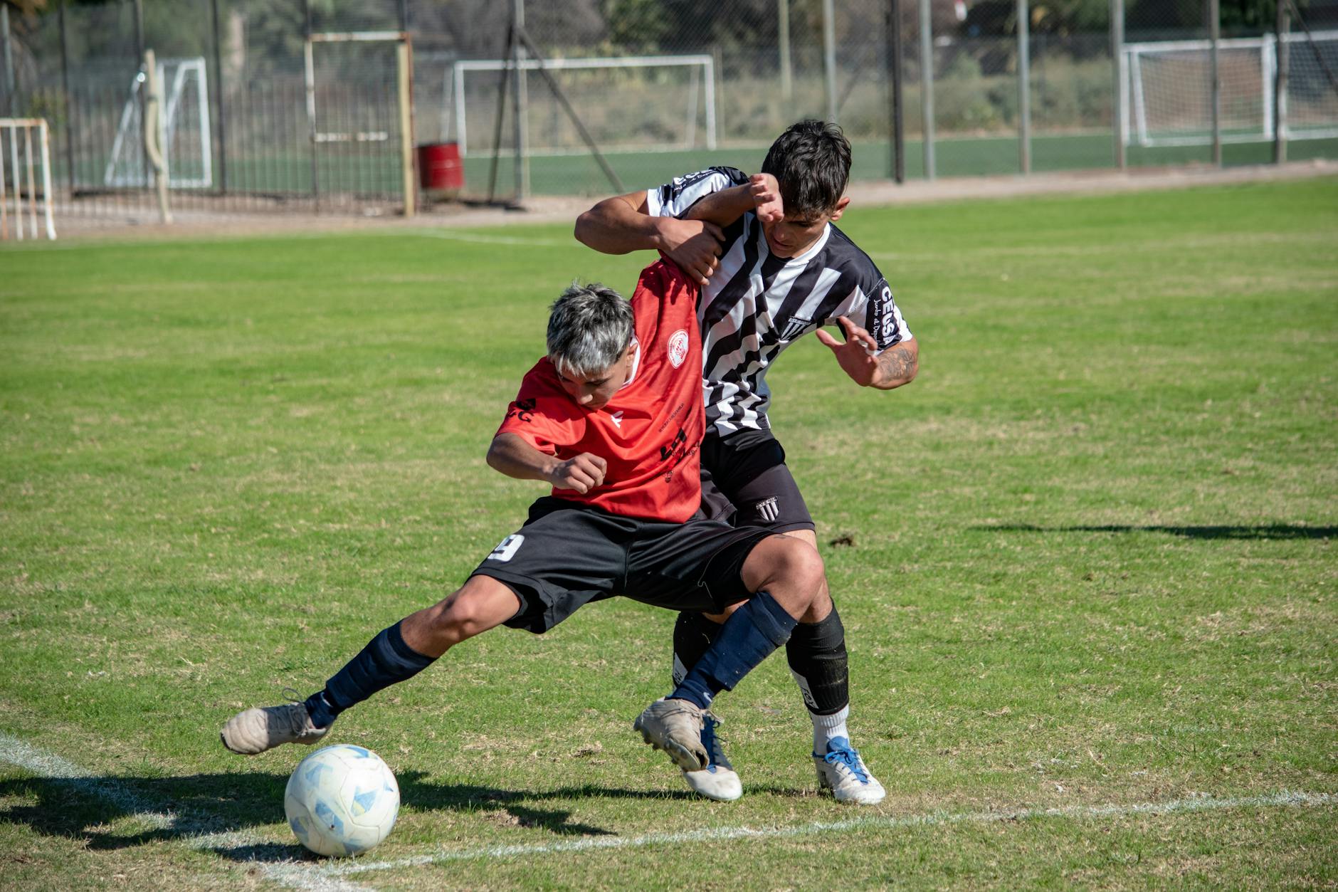 Two male soccer players in action on the field during a match.