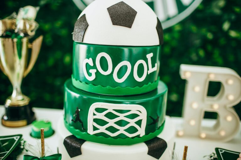Celebrate in style with a soccer-themed cake featuring a trophy and decorative accents.