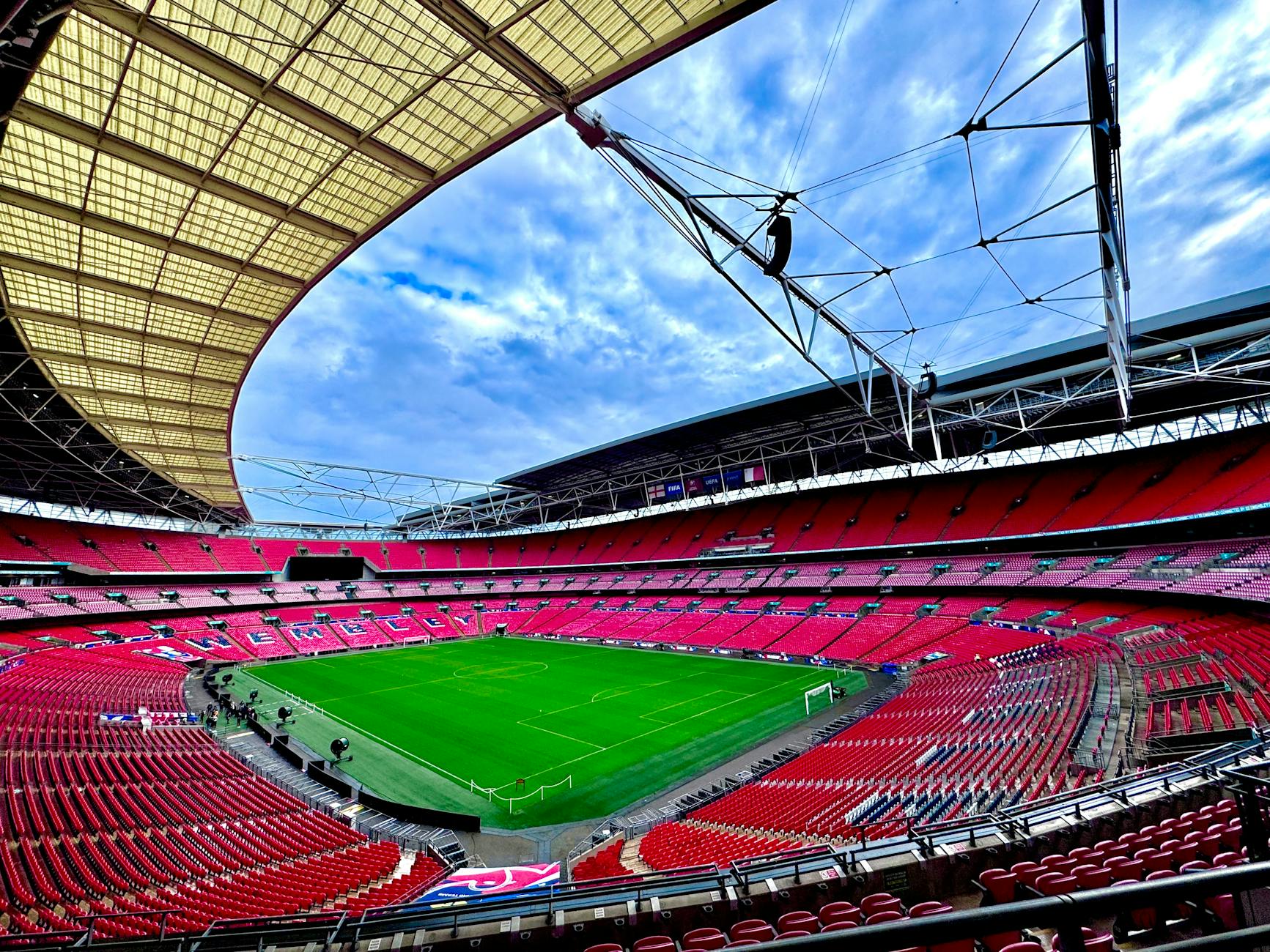 A stunning view of the iconic Wembley Stadium in London, capturing its vastness and architectural beauty.