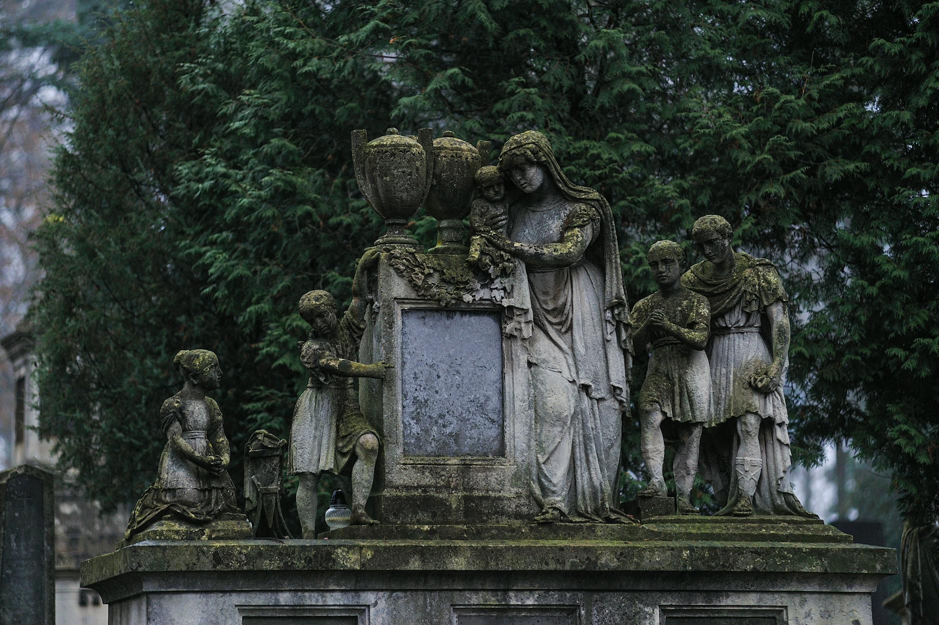 An ancient moss-covered sculpture in Lychakiv Cemetery, Lviv, Ukraine.