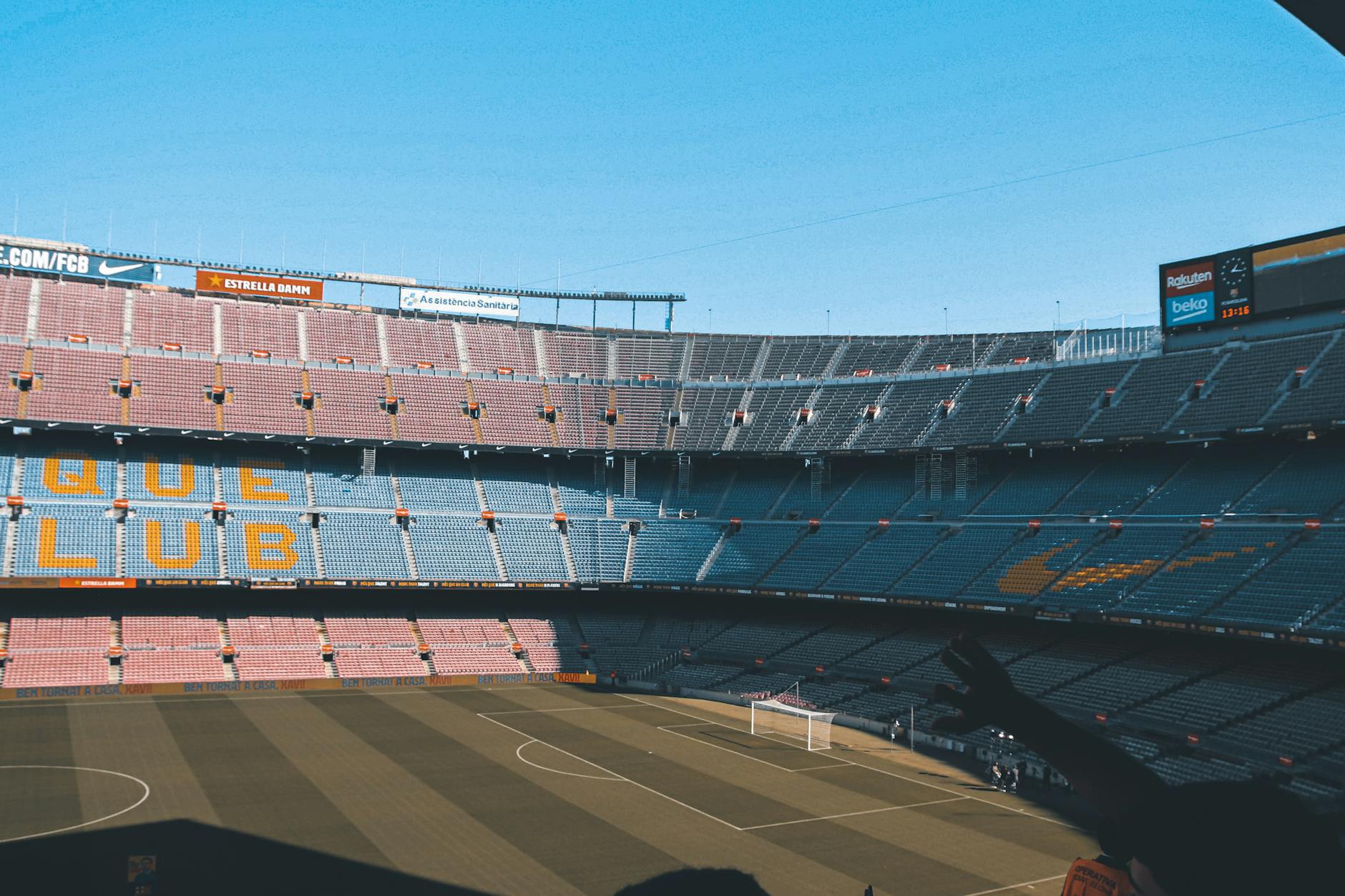 Wide shot of the iconic Camp Nou stadium in Barcelona, showcasing empty seats and football field.