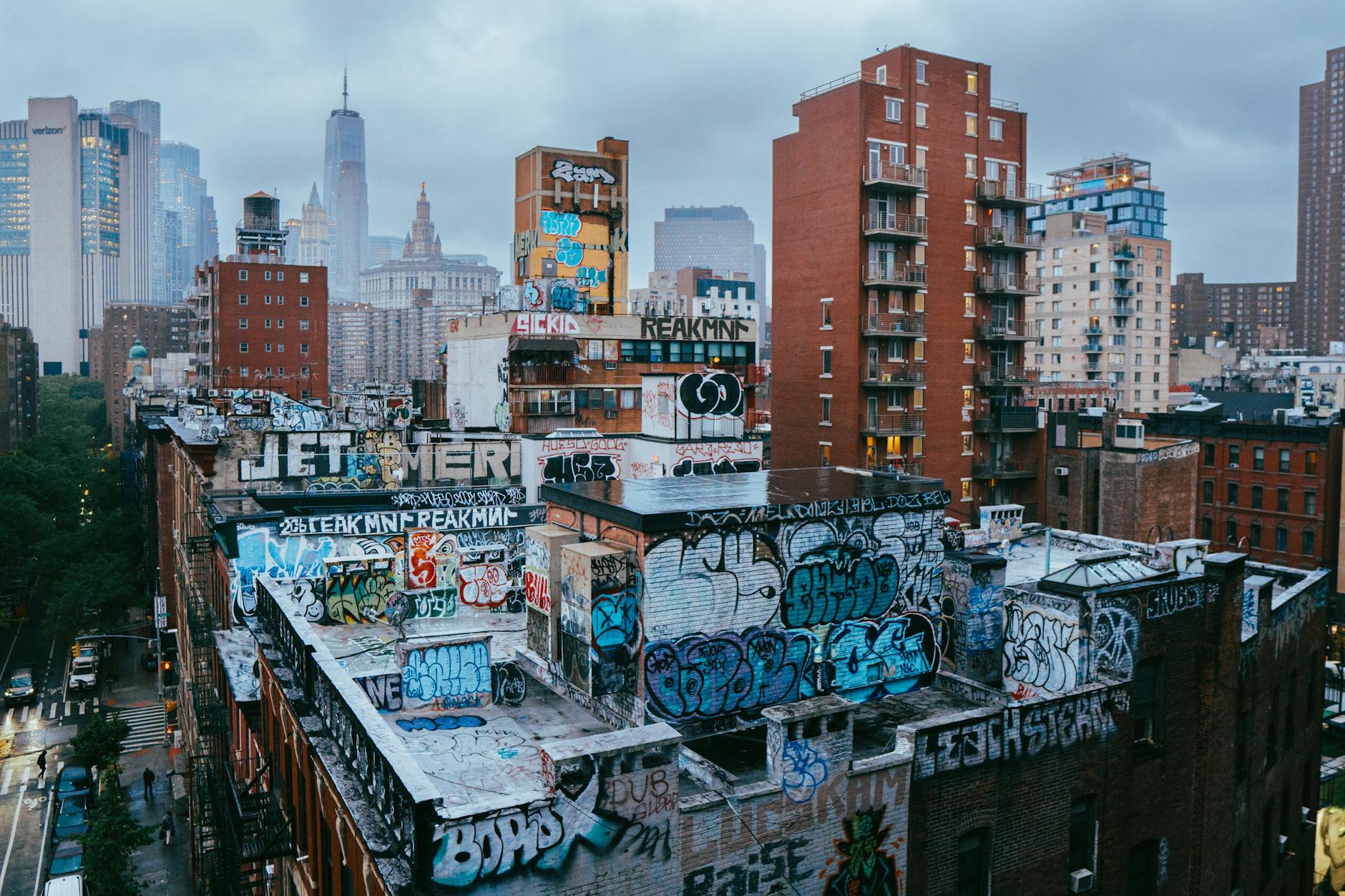 Dynamic scene of graffiti-covered rooftops in New York City's Manhattan.