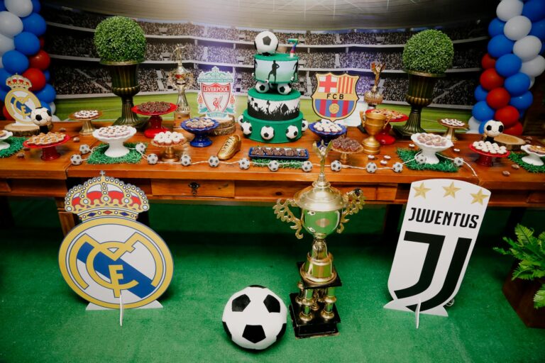 A vibrant football-themed dessert table with cakes, pastries, and iconic team logos, perfect for sports events or celebrations.