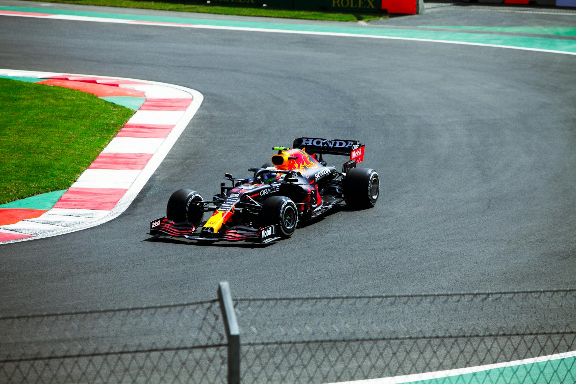 High-speed Formula One car racing at a circuit in Mexico City.