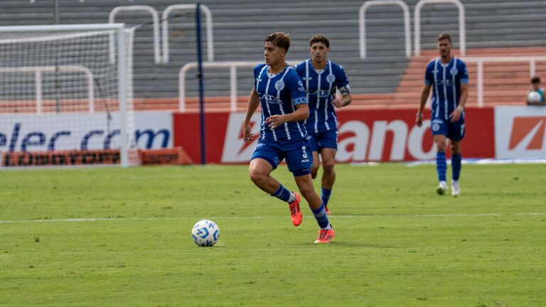 Exciting action shot of soccer players in blue jerseys during a match.