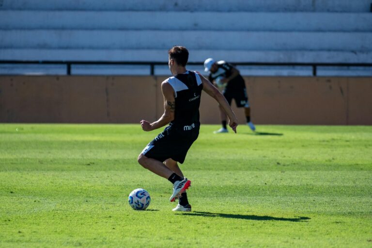 A soccer player training on a sunny day, showcasing agility and skill.