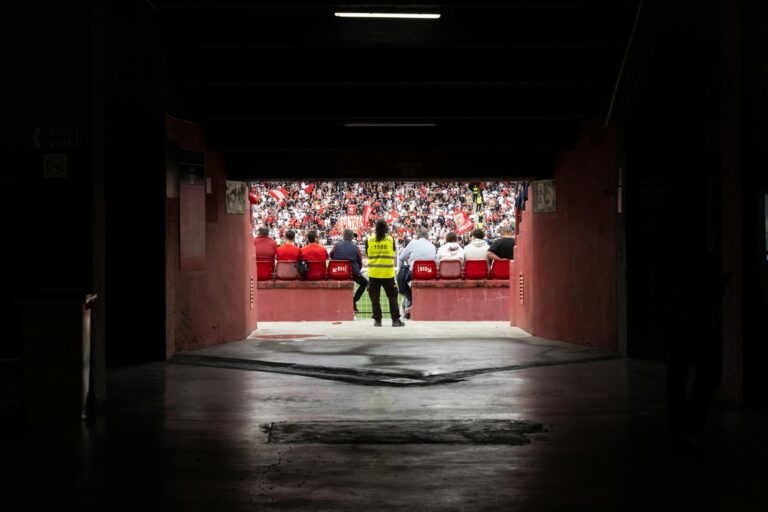 A dynamic stadium perspective through the tunnel showcasing engaged spectators during a game.