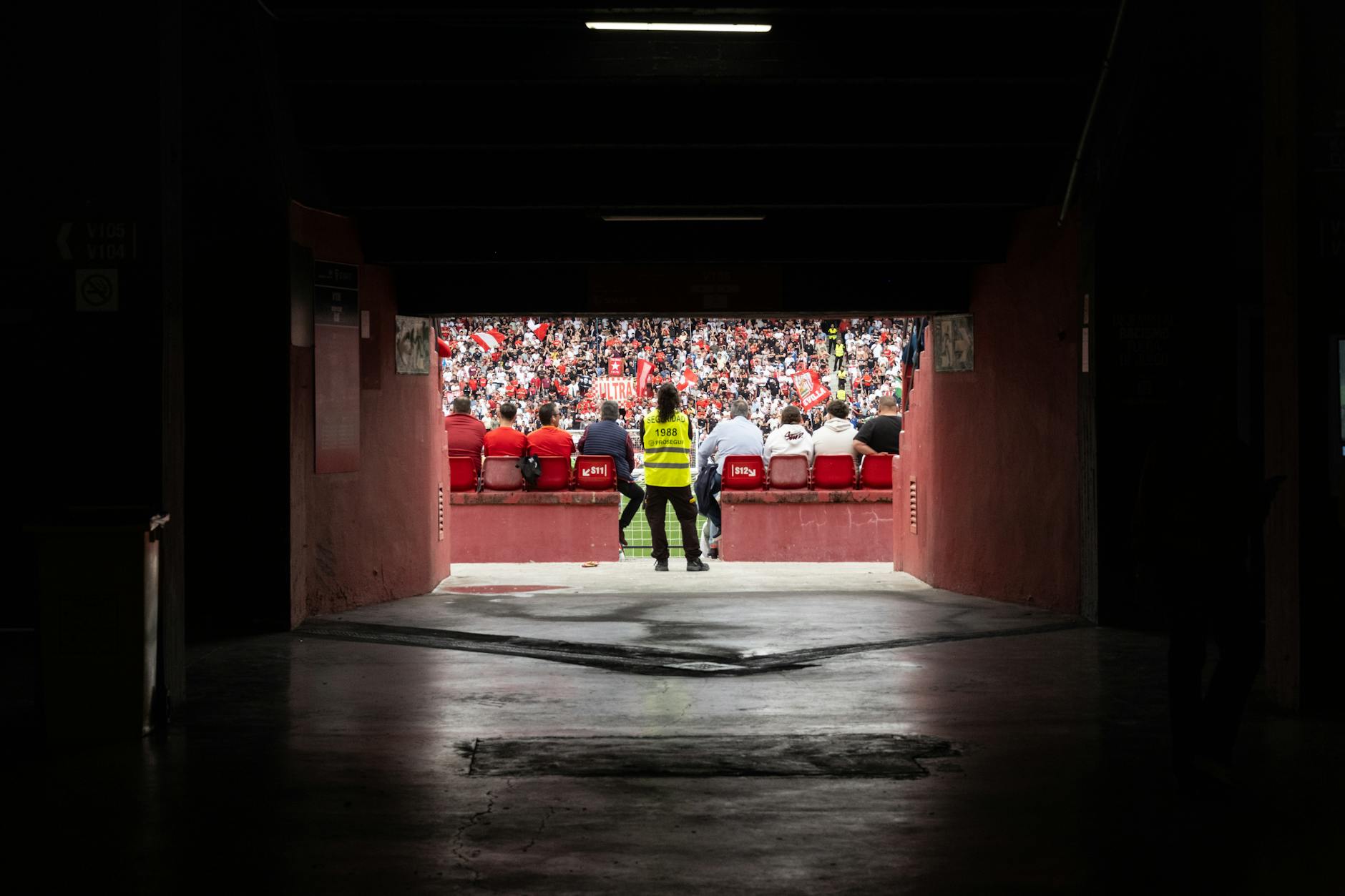 A dynamic stadium perspective through the tunnel showcasing engaged spectators during a game.