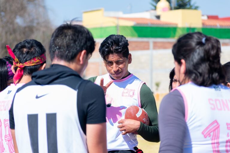 A youth football team strategizing during practice in Toluca de Lerdo, Mexico.