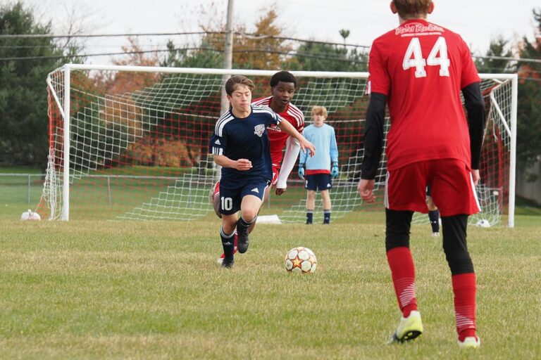 Dynamic action shot of teenage soccer game capturing intense competition and teamwork.