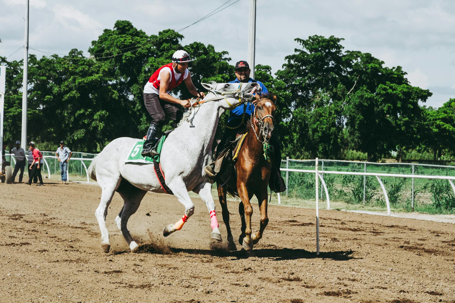 Dynamic scene of jockeys competing in a thrilling horse race outdoors.