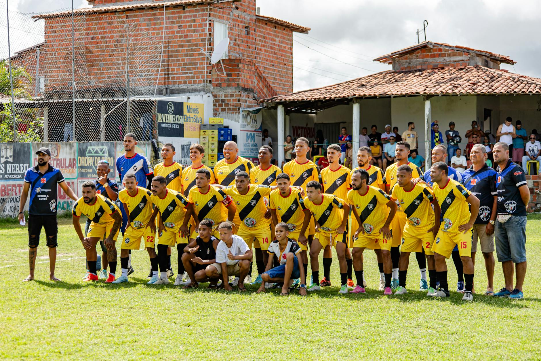Local amateur football team poses for a group photo before starting their match.