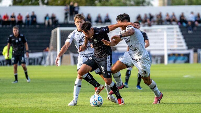 Dynamic action scene from a competitive soccer match with players in motion.