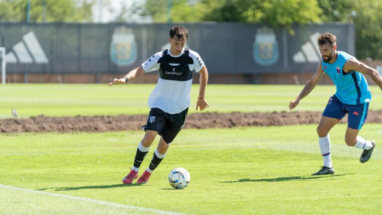 Two soccer players in action on a sunny day during an outdoor match.