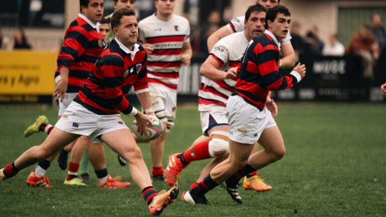 Dynamic shot of rugby players actively engaged in a game on a grass field.