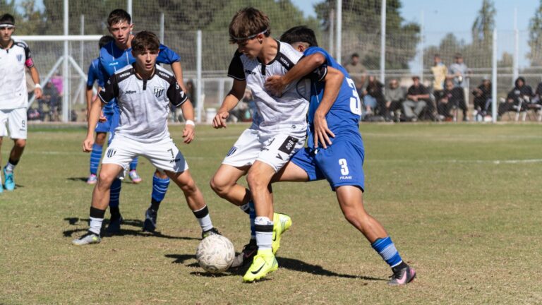 Intense moment of young soccer players competing in a match on a sunny day.