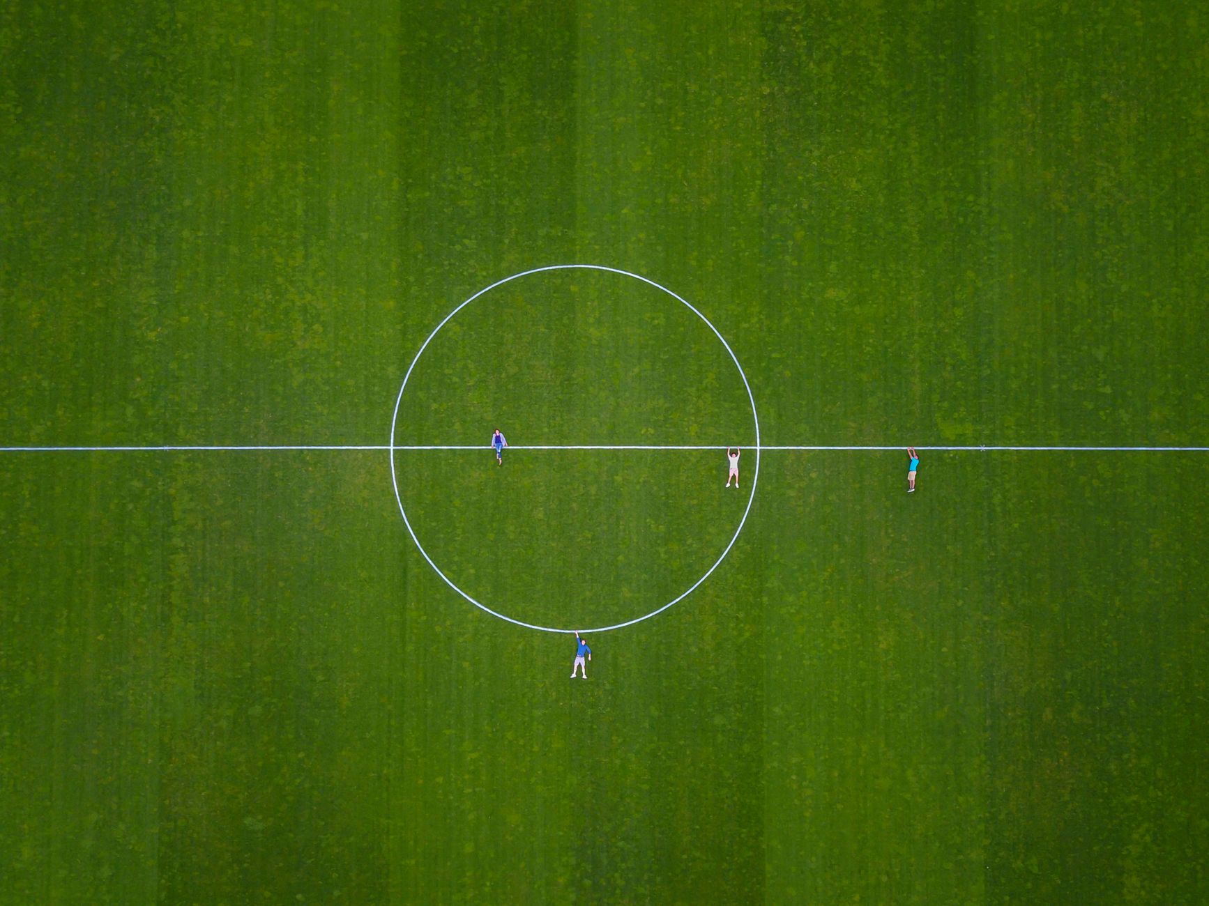 Aerial shot of people on a soccer field in Luzern, Switzerland.