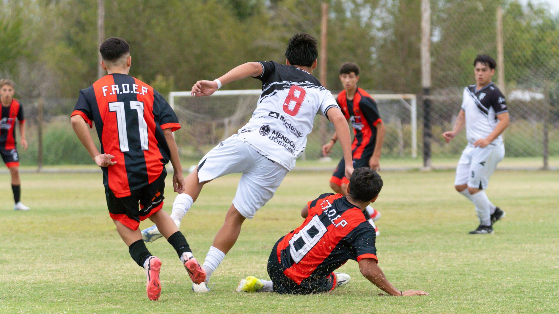 Young soccer players in action during an outdoor match, showcasing teamwork and sportsmanship.
