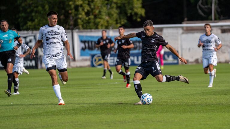 Dynamic soccer match highlighting players in action on a lush green field.