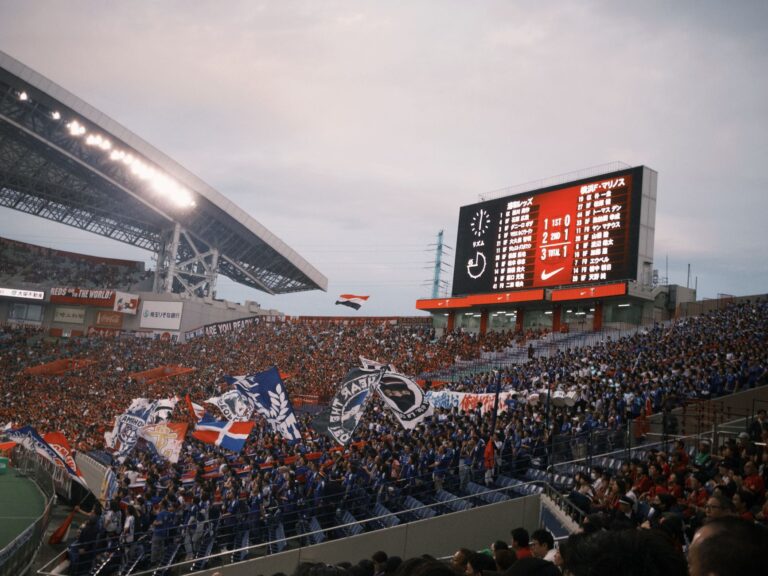 A vibrant soccer match with cheering fans at a packed stadium showcasing team spirit.