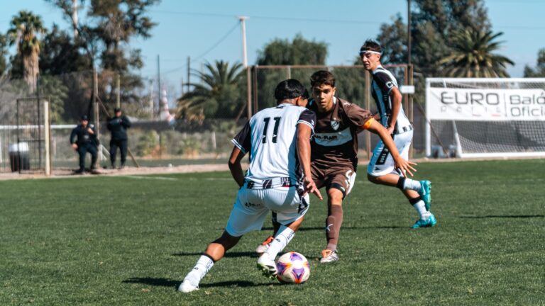 Dynamic outdoor youth soccer match with players in motion, showcasing teamwork and competitive spirit.