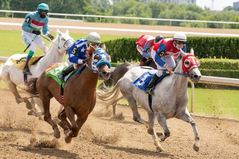 Thrilling horse race featuring jockeys competing fiercely on a sunny day.