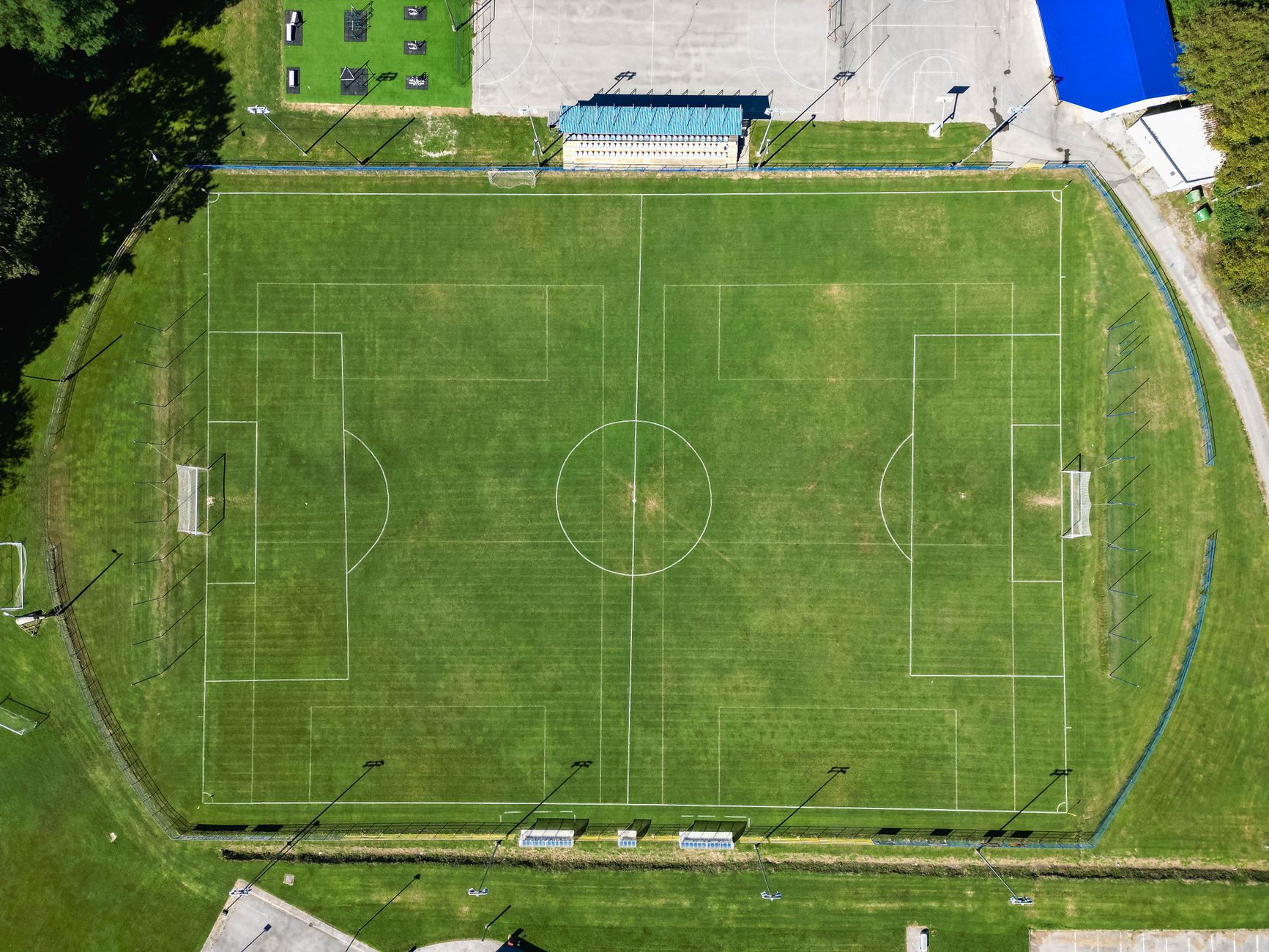 Aerial view of a soccer field in Garešnica, Croatia, showcasing vivid green pitches.