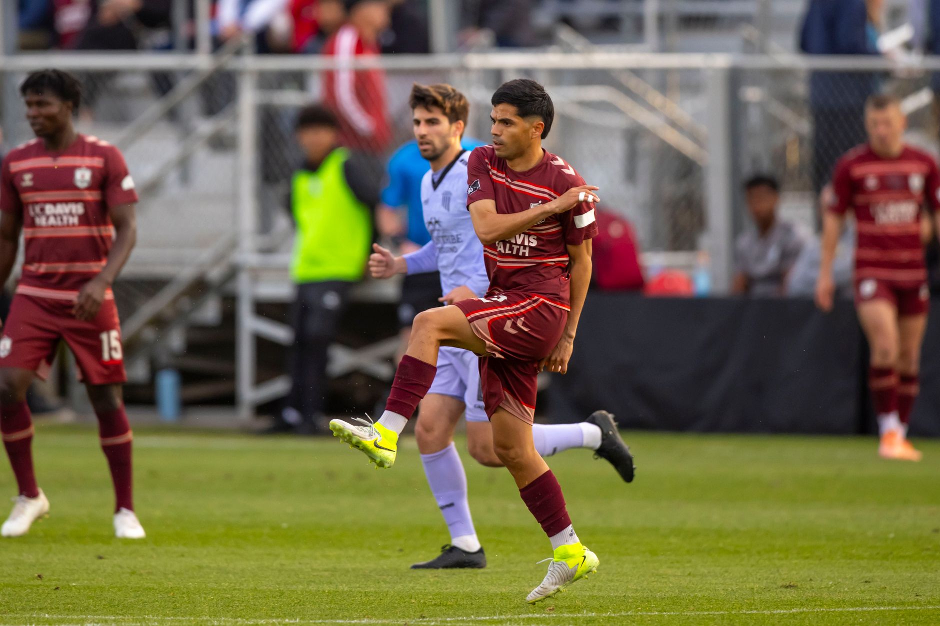 Intense action during a professional soccer match with players in motion on the field.