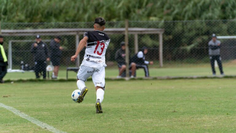 Dynamic image of a soccer player in action on a grassy field during a match.