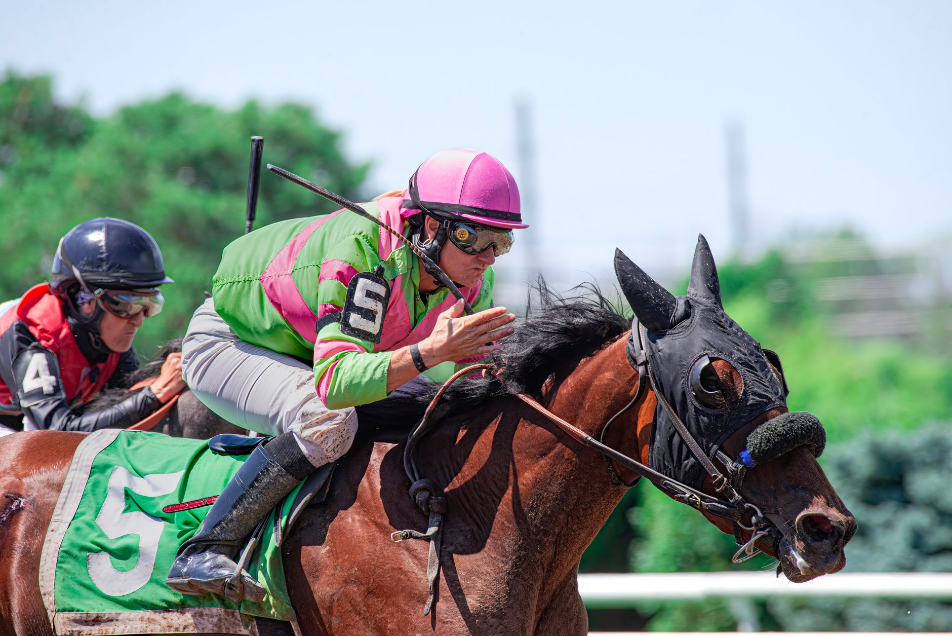 Intense horse racing action with jockeys competing on the track.