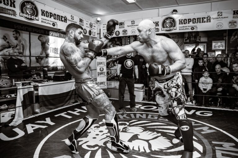 A dynamic black and white shot of a boxing fight in the ring capturing the energy and athleticism.