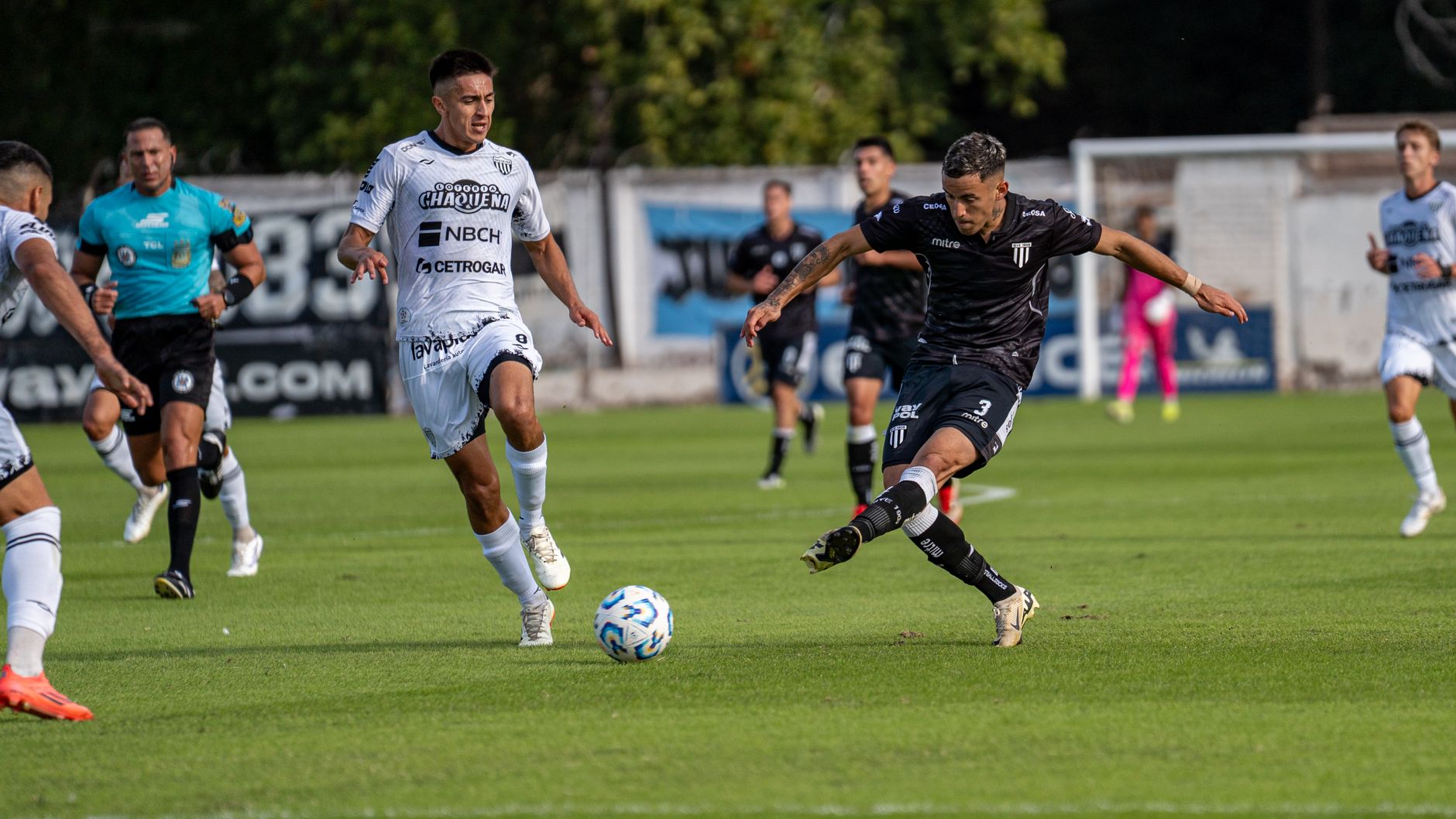 Dynamic soccer match capturing athletes in action on a vivid green field.