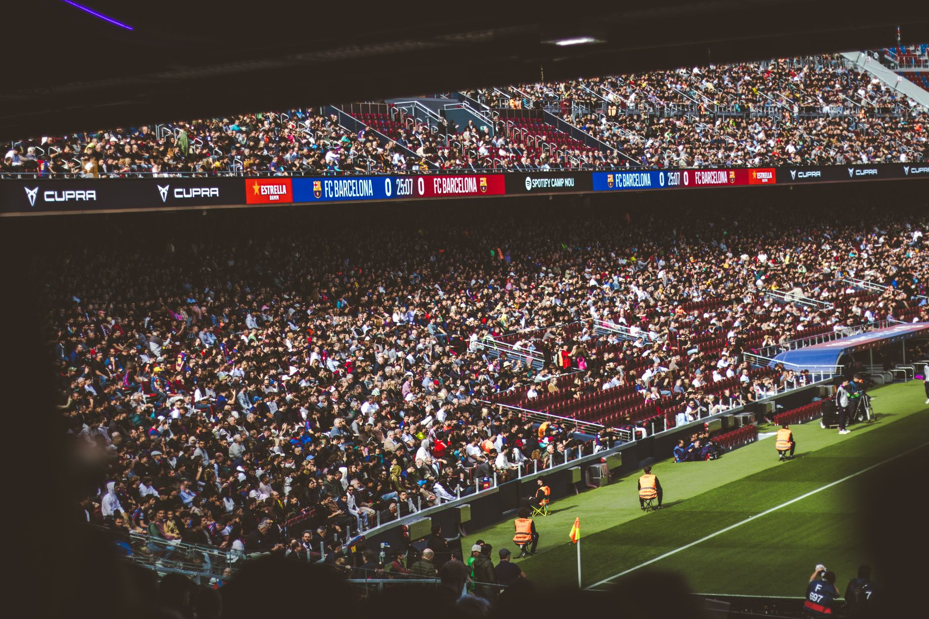 Packed stadium with spectators at an FC Barcelona soccer match, vibrant atmosphere.