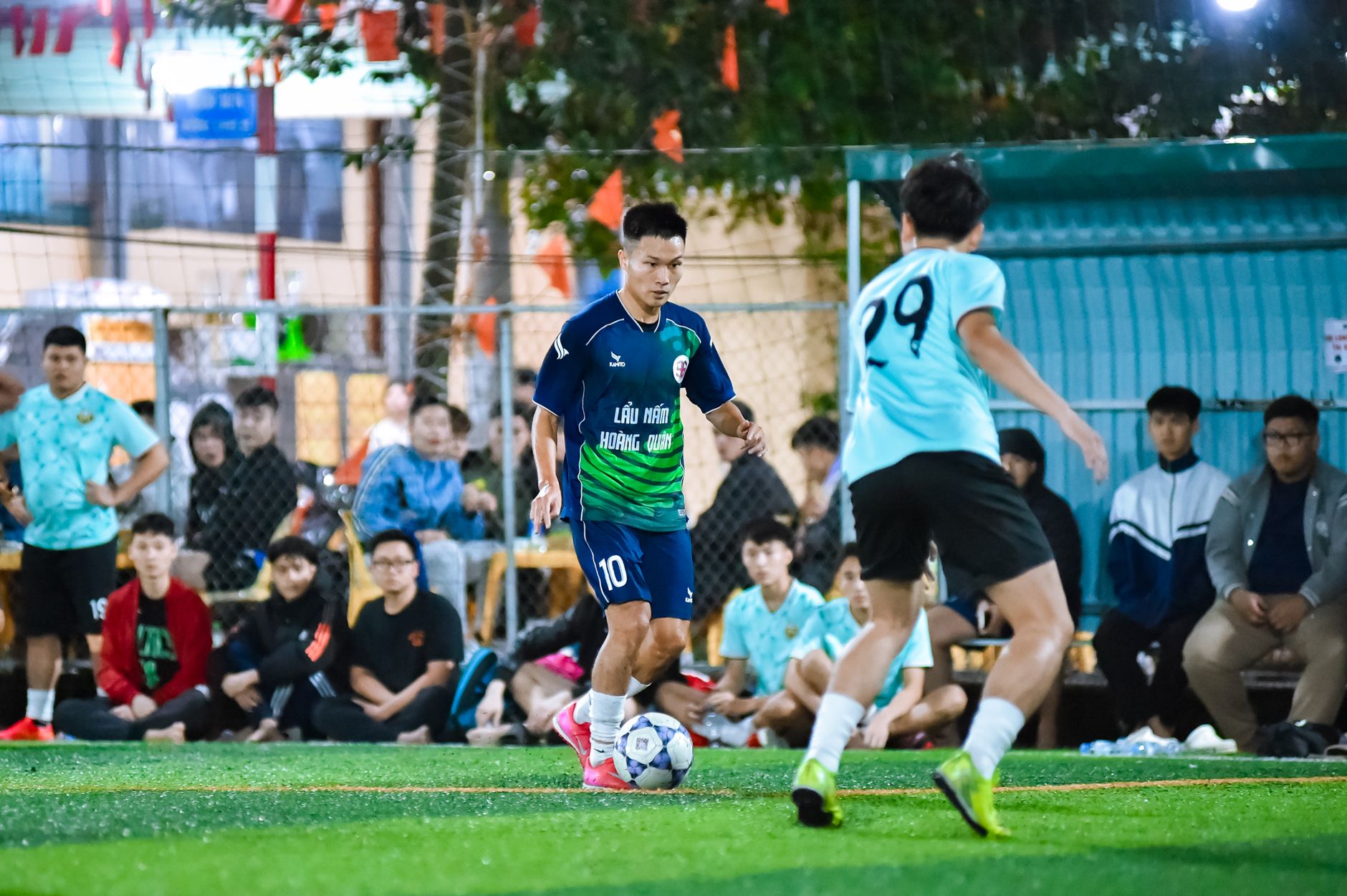 Amateur football players in action during a vibrant game in Hà Nội, Vietnam, showcasing sportsmanship and teamwork.